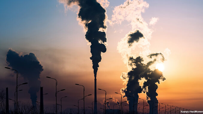 silhouette of a high industrial pipe with the sun behind it silhouette of a high industrial pipe with the sun behind it