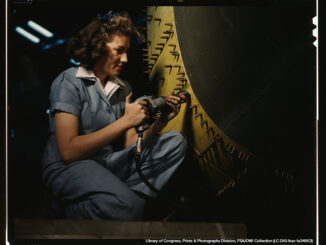 Riveter at work on Consolidated bomber, Consolidated Aircraft Corp., Fort Worth, Texas