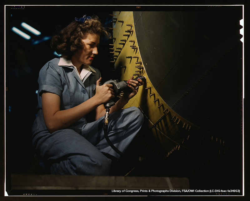 Riveter at work on Consolidated bomber, Consolidated Aircraft Corp., Fort Worth, Texas