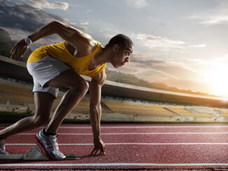 Sprinter leaving starting blocks on the running track