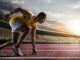 Sprinter leaving starting blocks on the running track