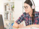 student learning on line with headphones and laptop