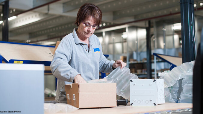 Female warehouse worker packing box for conveyor belt Female warehouse worker packing box for conveyor belt