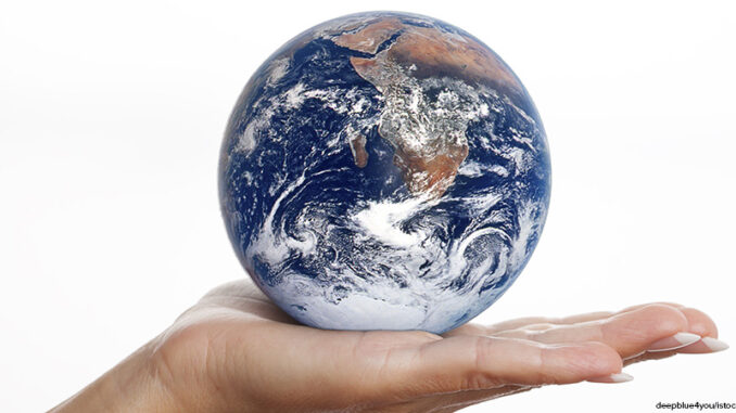 Globe earth glass ball in human hand isolated on white Globe earth glass ball in human hand isolated on white