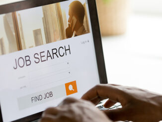 African man browsing work opportunities online using job search computer app,