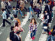 woman standing in crowd of pedestrians