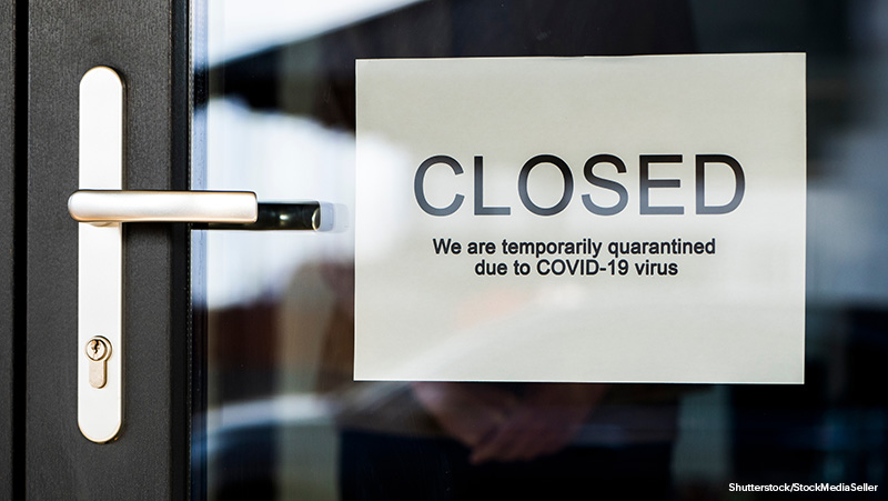 Business owner hangs on door announcement of closure due to coronavirus quarantine.;