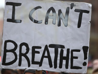 Close-up view of a sign reading "I Can't Breathe"