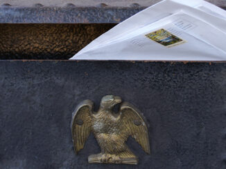 home-mounted mailbox with letter sticking out the top