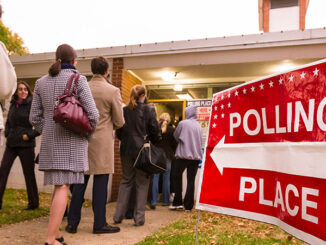 people line up to vote outside a polling place