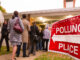 people line up to vote outside a polling place