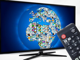 Widescreen high definition TV screen with sphere video gallery. Remote control in hand