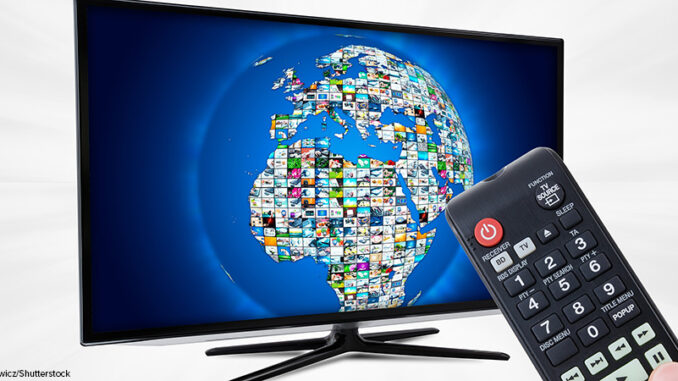 Widescreen high definition TV screen with sphere video gallery. Remote control in hand Widescreen high definition TV screen with sphere video gallery. Remote control in hand