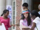 a roup of young people assisting in a voter registration drive