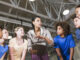 Group of children with coach in school gym