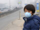Boy in Beijing China wearing mouth mask against air pollution