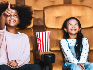 girls sitting in a movie theater