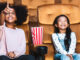 girls sitting in a movie theater