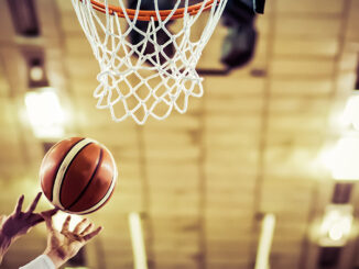 Basketball going in hoop at basketball game