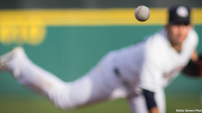 041221_01P_FS A baseball in motion with pitcher in background.