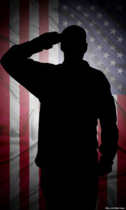 Silhouette of American (USA) soldier saluting to USA flag
