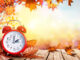 alarm clock on autumnal background