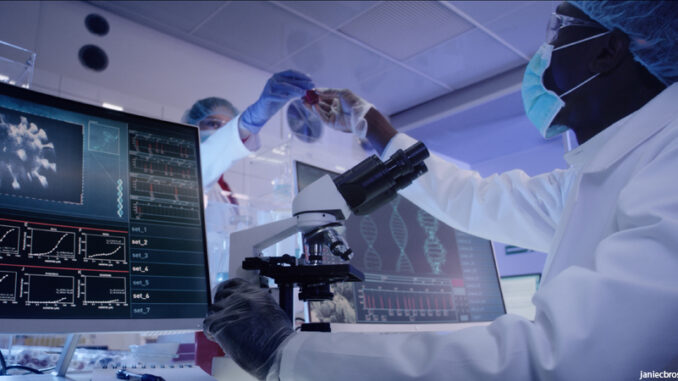 Young african ethnicity microbiologist studying coronavirus. Looking through microscope Microbiologist studying coronavirus with microscope