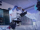 Microbiologist studying coronavirus with microscope