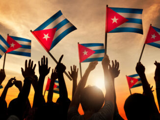 Silhouettes of People Holding Flag of Cuba