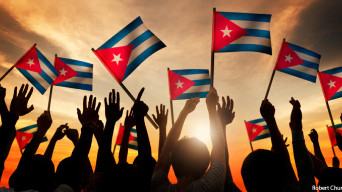 Silhouettes of People Holding Flag of Cuba Silhouettes of People Holding Flag of Cuba