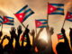 Silhouettes of People Holding Flag of Cuba