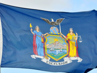 Flag of New York State in blue sky background