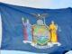 Flag of New York State in blue sky background