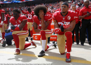 Colin Kaepernick (7) and other members of the San Francisco 49ers kneel during the national anthem before a game in 2016.