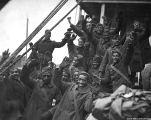 African Americans, members of 369th Colored Infantry, wave from a troop ship as they arrive back in New York City.