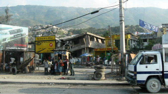 Haitians standing near a earthquake-damaged building Haitians standing near a earthquake-damaged building
