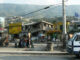 Haitians standing near a earthquake-damaged building