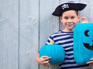 boy holds a teal pumpkins. Teal Pumpkin Project