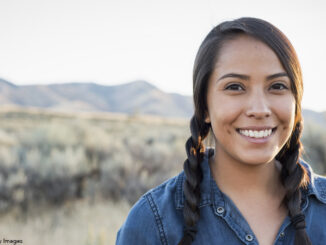 Native American woman standing outside