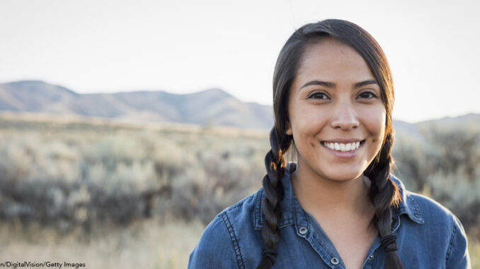 Young Native American woman outdoors at sunset Native American woman standing outside