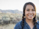 Native American woman standing outside