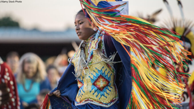 Native American woman performing grass dance during Sac & Fox nation Pow-wow, Stroud, Oklahoma, U.S.A. Native American woman performing grass dance in traditional attire