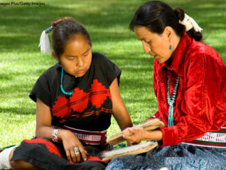 A Navajo woman and child working on a weaving project