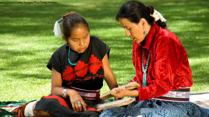 Learning how to weave A Navajo woman and child working on a weaving project