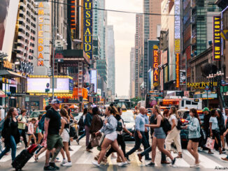 Crowds of people crossing street on zebra crossing in New York CIty.