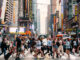 Crowds of people crossing street on zebra crossing in New York CIty.
