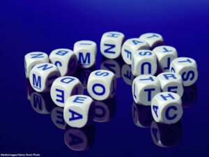 a pile of white letter cubes on a blue surface