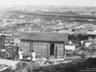 Building reconstruction in Tulsa, Okla. This part of town was demolished by fire in the race riots of June 1921.