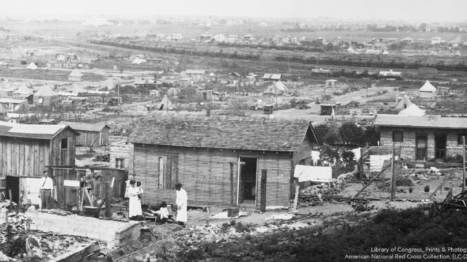 Building reconstruction in Tulsa, Okla. This part of town was demolished by fire in the race riots of June 1921.