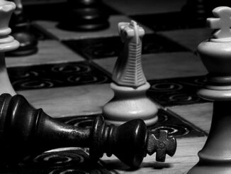 black and white photograph of chess pieces on a chess board